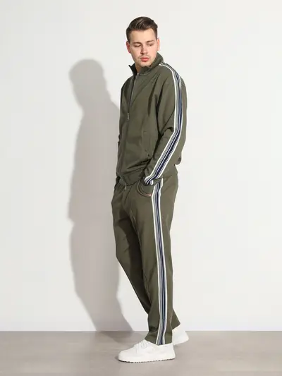 Брюки трикотажные зеленого цвета с лампасами из смесового хлопка